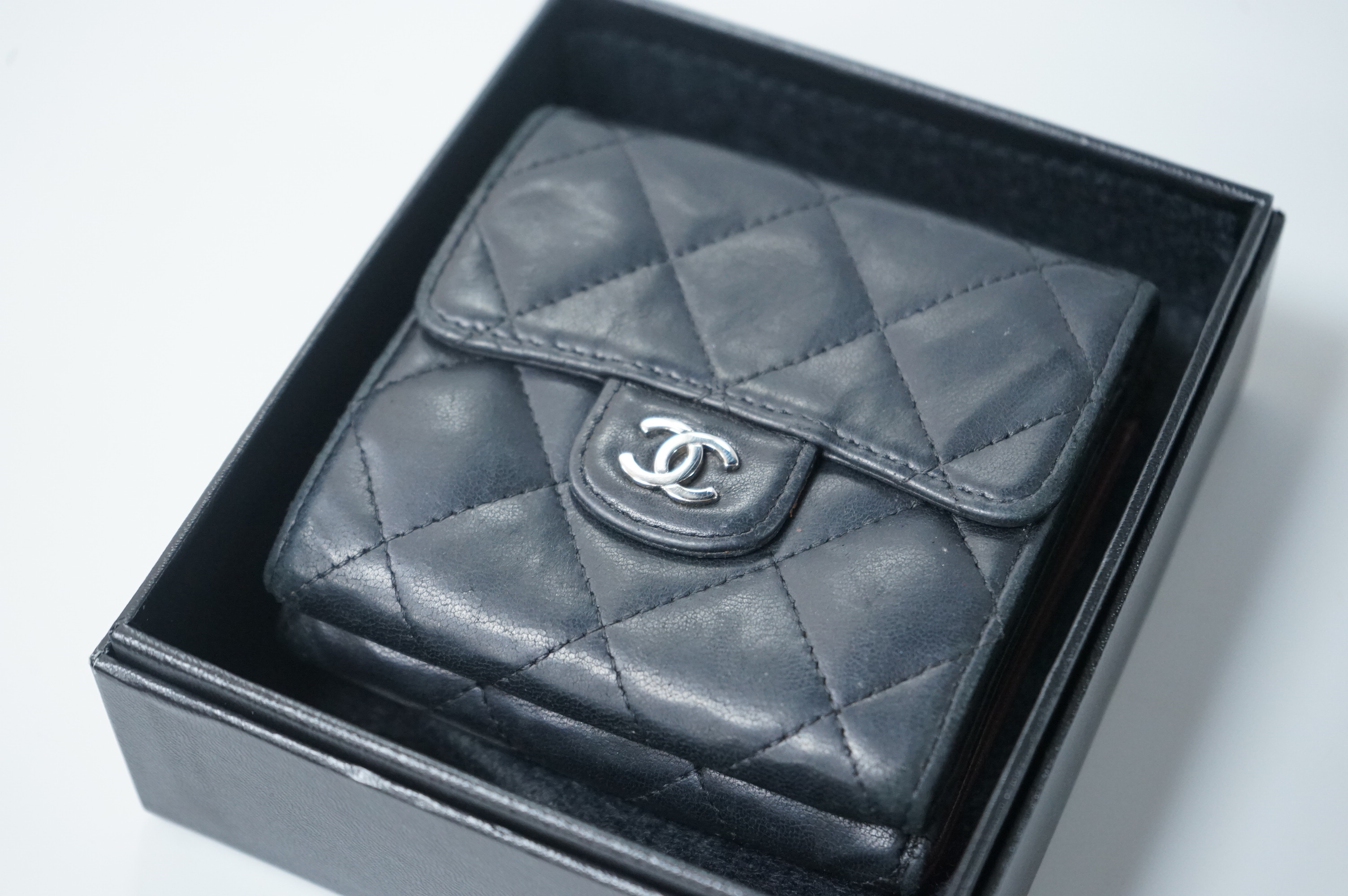 A Chanel classic double flap black leather purse, with original receipt, authenticity card numbered 10670211 and box, 10cm wide, Provenance: Purchased by the vendor in New York